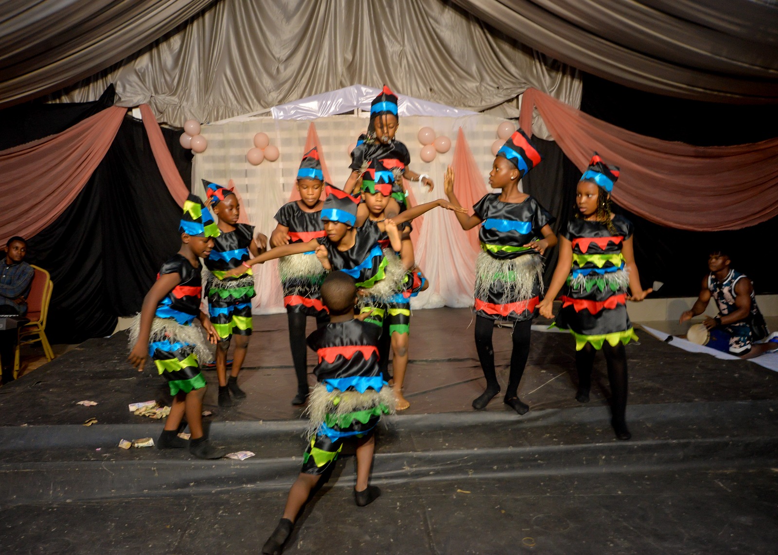 Pupils in traditional attire with talking drums